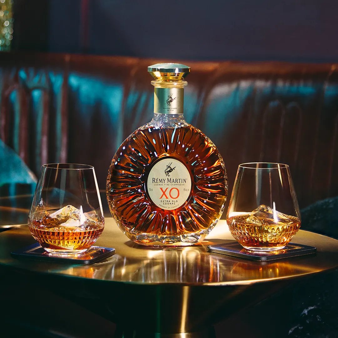 Rémy Martin XO with two glasses on a gold table